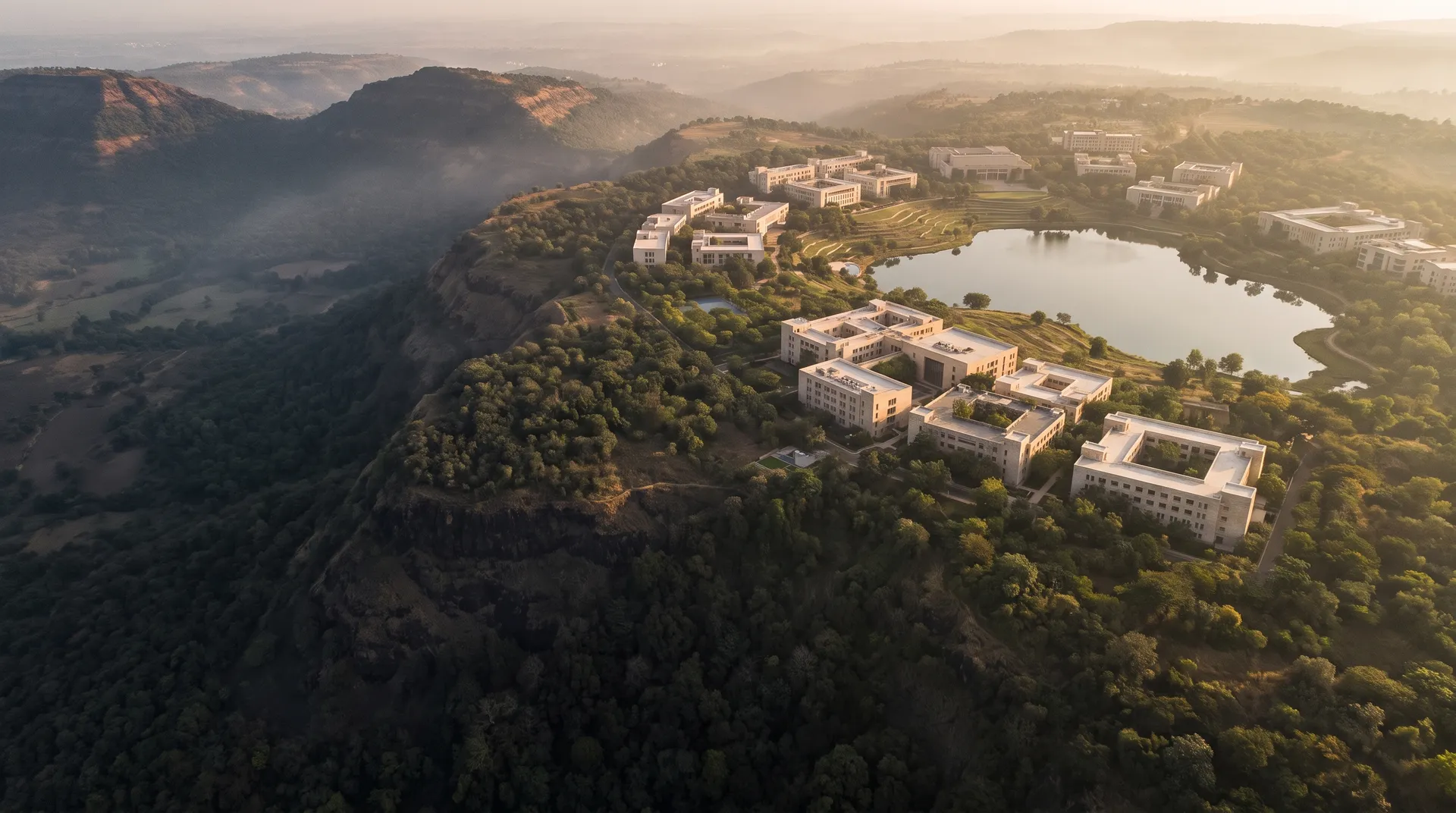 Artist’s impression of a proposed academic landscape with low-rise buildings, lake and forest, inspired by the Deccan plateau. Not an actual site.